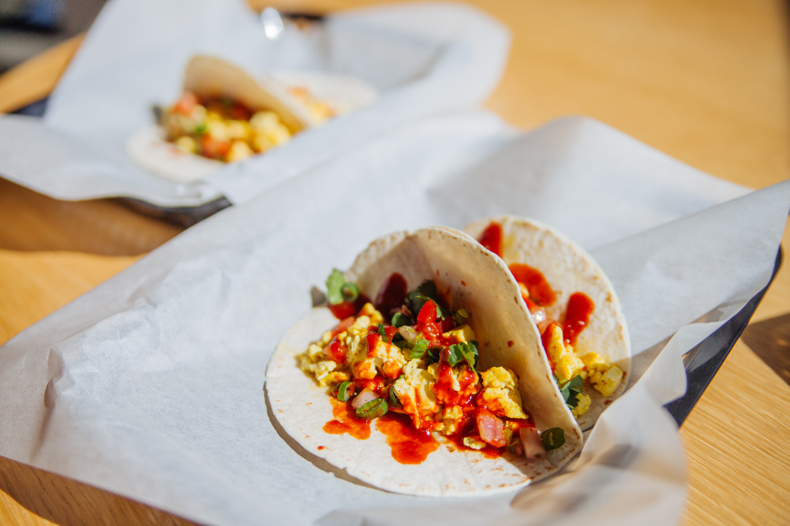 Tofu breakfast tacos on a table, credit Heather Mount